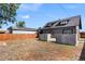 Backyard features a gray home, wooden fence, solar panels, and a concrete patio to entertain guests at 2253 S Fox St, Denver, CO 80223