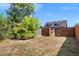 Backyard has mature trees and a wooden fence for added privacy at 2253 S Fox St, Denver, CO 80223