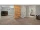 Finished basement rec room features neutral carpet and a doorway that leads into the bedroom at 2253 S Fox St, Denver, CO 80223