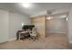 Finished basement area with an office space, neutral carpet, and a modern light fixture at 2253 S Fox St, Denver, CO 80223