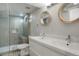 Modern bathroom featuring a double vanity, sleek fixtures and a glass-enclosed shower at 2253 S Fox St, Denver, CO 80223