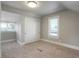 Well lit bedroom has neutral paint, large closet, natural light from single window, and carpeted floors at 2253 S Fox St, Denver, CO 80223
