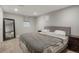 Cozy bedroom with carpet, a modern gray bedframe and headboard, and a dark wood nightstand at 2253 S Fox St, Denver, CO 80223