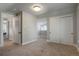A bedroom boasts neutral walls, carpeted floors, a closet, and bright natural light from a set of windows at 2253 S Fox St, Denver, CO 80223