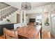 Inviting dining area with a large table, stylish lighting, and easy access to the staircase at 2253 S Fox St, Denver, CO 80223