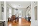 Bright dining room featuring hardwood floors, modern lighting and access to the staircase and backyard at 2253 S Fox St, Denver, CO 80223
