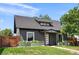 Charming home featuring a well-manicured lawn, gray siding and stylish planters enhancing the curb appeal at 2253 S Fox St, Denver, CO 80223