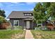 Charming gray home featuring a well-manicured lawn and lovely curb appeal at 2253 S Fox St, Denver, CO 80223