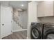 Functional laundry area with modern appliances and easy access to stairs at 2253 S Fox St, Denver, CO 80223
