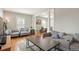 Bright living room featuring hardwood floors, comfortable seating and neutral tones at 2253 S Fox St, Denver, CO 80223