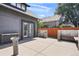 Concrete patio featuring a gray home, wooden fence, and outdoor seating perfect for entertaining guests at 2253 S Fox St, Denver, CO 80223