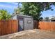 Backyard shed with a wooden fence perfect for extra storage in the yard at 2253 S Fox St, Denver, CO 80223