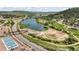 This aerial view showcases a tranquil lake, tennis courts, and scenic surroundings, highlighting the community's amenities at 114 Vale St, Palmer Lake, CO 80133