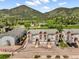 Panoramic aerial view of the townhome complex nestled against a backdrop of lush green mountains and trees at 114 Vale St, Palmer Lake, CO 80133