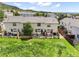 Townhome backyard featuring a wooden fence and lush green lawn at 114 Vale St, Palmer Lake, CO 80133