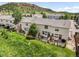 Townhome backyard featuring a wooden fence and lush green lawn at 114 Vale St, Palmer Lake, CO 80133