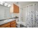 Functional bathroom featuring a vanity, toilet, and shower-tub combination with a shower curtain at 114 Vale St, Palmer Lake, CO 80133