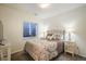 Comfortable bedroom featuring a cozy bed, side tables, and a bright window at 114 Vale St, Palmer Lake, CO 80133