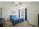 Bright bedroom featuring a queen bed with a floral comforter and a ceiling fan for comfort at 114 Vale St, Palmer Lake, CO 80133