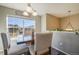 Dining area featuring a wood table, upholstered chairs, and a large window with bright, natural light at 114 Vale St, Palmer Lake, CO 80133