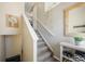 Inviting entryway with a staircase leading to the upper level, decorated with a stylish mirror and hanging plants at 114 Vale St, Palmer Lake, CO 80133