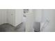 Bright hallway with neutral carpeting and trim leading to bedrooms, stairs to basement, and scenic window view at 114 Vale St, Palmer Lake, CO 80133