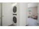 Convenient laundry area featuring a stacked washer and dryer with access to a carpeted bonus room at 114 Vale St, Palmer Lake, CO 80133