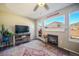 Comfortable living room with a fireplace, scenic mountain views, a ceiling fan, and a stylish rug at 114 Vale St, Palmer Lake, CO 80133