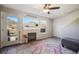 Cozy living room featuring a fireplace, natural light, stylish decor, and a ceiling fan at 114 Vale St, Palmer Lake, CO 80133