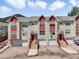 Charming townhomes with red accents, private entrances, and attached garages at 114 Vale St, Palmer Lake, CO 80133