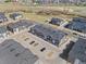 Drone shot of a townhome community featuring modern architecture, parking, and green spaces at 132 Ambrose St, Erie, CO 80516