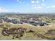 Scenic aerial view of a modern community nestled near open spaces with a mountain backdrop at 132 Ambrose St, Erie, CO 80516