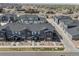 Aerial view of new townhome community with dark roofs, covered porches, and well-maintained landscaping at 132 Ambrose St, Erie, CO 80516