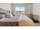 Bright bedroom with a large window offering neighborhood views at 132 Ambrose St, Erie, CO 80516