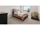 Cozy bedroom features a comfortable bed and natural light from the window at 132 Ambrose St, Erie, CO 80516
