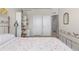 Comfortable bedroom features a floral bedspread, white doors and trim, and a decorative metal frame at 132 Ambrose St, Erie, CO 80516