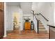 Inviting foyer with wood floors, staircase, and a half bathroom at 132 Ambrose St, Erie, CO 80516