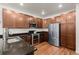 Gourmet kitchen with stainless appliances, granite countertops and wood floors at 132 Ambrose St, Erie, CO 80516