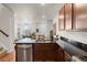 Stylish kitchen featuring dark countertops, stainless steel appliances, and modern cabinets at 132 Ambrose St, Erie, CO 80516