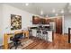 Modern kitchen with stainless steel appliances and a breakfast bar with seating at 132 Ambrose St, Erie, CO 80516