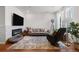 Bright living room with a fireplace, comfortable seating, and large windows at 132 Ambrose St, Erie, CO 80516