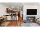Open-concept living room with a modern fireplace and wood floors at 132 Ambrose St, Erie, CO 80516