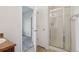 Bathroom with a glass-enclosed shower, vanity, and doorway to the bedroom at 12921 Grant Cir # B, Thornton, CO 80241