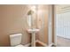 Powder room with pedestal sink, oval mirror, and storage closet at 12921 Grant Cir # B, Thornton, CO 80241