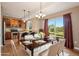Bright dining area features hardwood floors, elegant chandelier, and sliding glass doors to the backyard at 12921 Grant Cir # B, Thornton, CO 80241