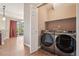 Spacious laundry room with stainless steel Samsung washer and dryer, shelving, and patio access at 12921 Grant Cir # B, Thornton, CO 80241