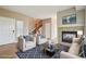 Inviting living room with a cozy fireplace, plush seating, and staircase at 12921 Grant Cir # B, Thornton, CO 80241