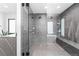 Modern bathroom with a glass-enclosed shower, soaking tub, and sleek gray tiling at 2838 Tennyson St, Denver, CO 80212