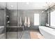 Bathroom with a modern design including a glass shower, floating shelves, and a freestanding tub at 2838 Tennyson St, Denver, CO 80212