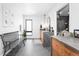 Bright bathroom with double sink vanity with dark marble counters, dark tile floor, and modern bench at 2838 Tennyson St, Denver, CO 80212
